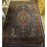 A Kashan red and blue ground rug, 220 x 142cm