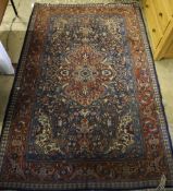 A Kashan red and blue ground rug, 220 x 142cm