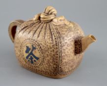 A 19th century Yixing parcel shaped teapot, impressed makers marks, 18cm across, 10cm high