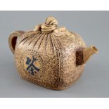 A 19th century Yixing parcel shaped teapot, impressed makers marks, 18cm across, 10cm high
