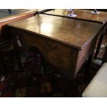 A George III oak low boy, with one long and two short drawers, with brass drop handles, on square