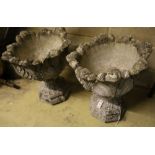 A pair of reconstituted stone leaf pattern garden urns, height 58cm