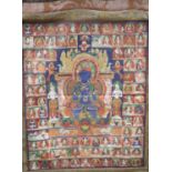 A Tibetan painted silk thangka with a blue Buddha surrounded by figures, central panel 54 x 43cm,