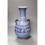 A large Chinese bulbous blue vase, with mask and ring handles, 45cm
