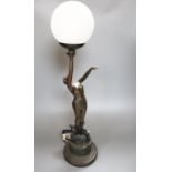 An Art Deco style bronzed resin figural table lamp, semi-nude female holding glass shade aloft, 66cm
