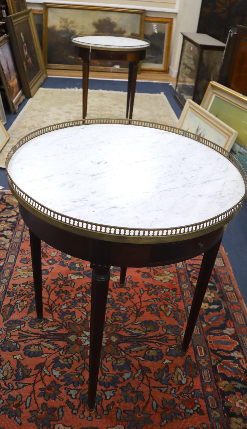 A pair of French style mahogany occasional tables with brass galleried marble tops, 65cm diameter,
