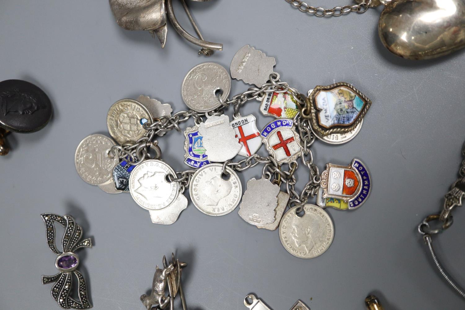 A white metal charm bracelet hung with enamel medallions, one other charm bracelet, marcasite - Image 2 of 5