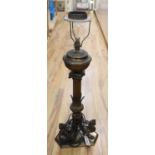 A 19th century gilt bronze and brass oil lamp on tri-form dragon supports (converted for