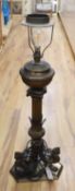 A 19th century gilt bronze and brass oil lamp on tri-form dragon supports (converted for