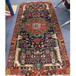 A Persian red ground rug, 282 x 134cm