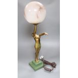 An Art Deco spelter figural table lamp, with semi-nude dancer holding a glass shade aloft, 64cm