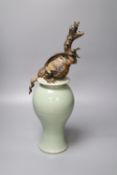 A Chinese celadon vase and cover having later cold-painted metal dragon terminal (repair)