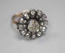 An antique yellow metal and diamond set circular cluster ring, (adapted?), size K/L, gross 3.5