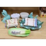 A Majolica style asparagus stand, a dish, graduated rabbits, a celery dish, and two jelly moulds,
