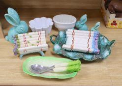 A Majolica style asparagus stand, a dish, graduated rabbits, a celery dish, and two jelly moulds,