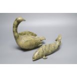 A carved Inuit whale and a similar carved swan