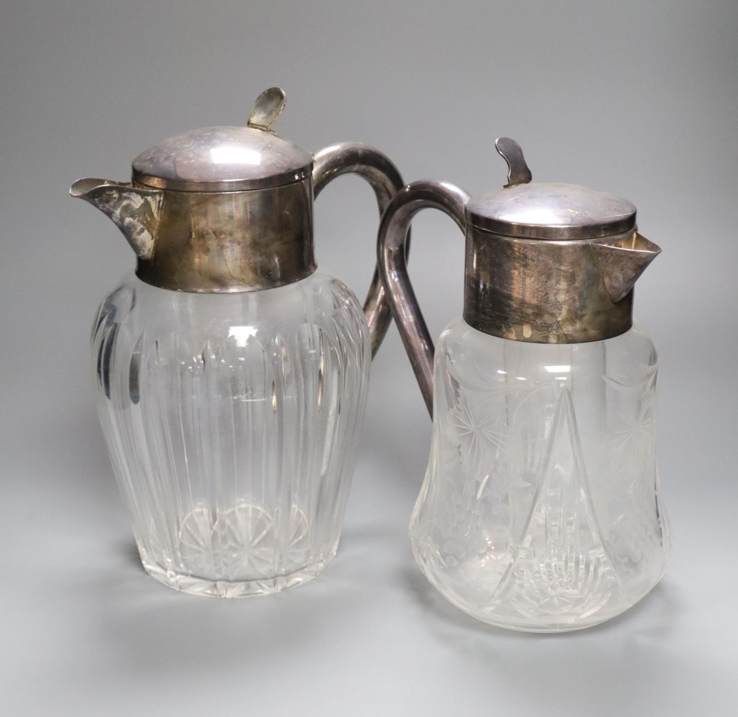 Two silver plated and glass lemonade jugs, 27cm and 24cm