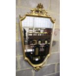 A gilt framed shield shape wall mirror, 56 x 110cm