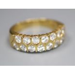 A modern 18ct gold and fifteen stone two row diamond set half hoop ring, size O, gross 6.6 grams.