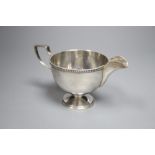 A George V silver pedestal cream jug, Walker & Hall, Sheffield, 1930, 85mm, gross 130 grams.