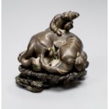 A Chinese bronze scroll weight in the form of an elephant and child, on carved and pierced