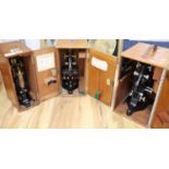 Three various cased microscopes