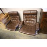 A pair of Erkones brown leather and chrome reclining armchairs