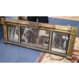 A Regency mahogany gilt-framed overmantel mirror centred by a military trophy, 160 x 60cm