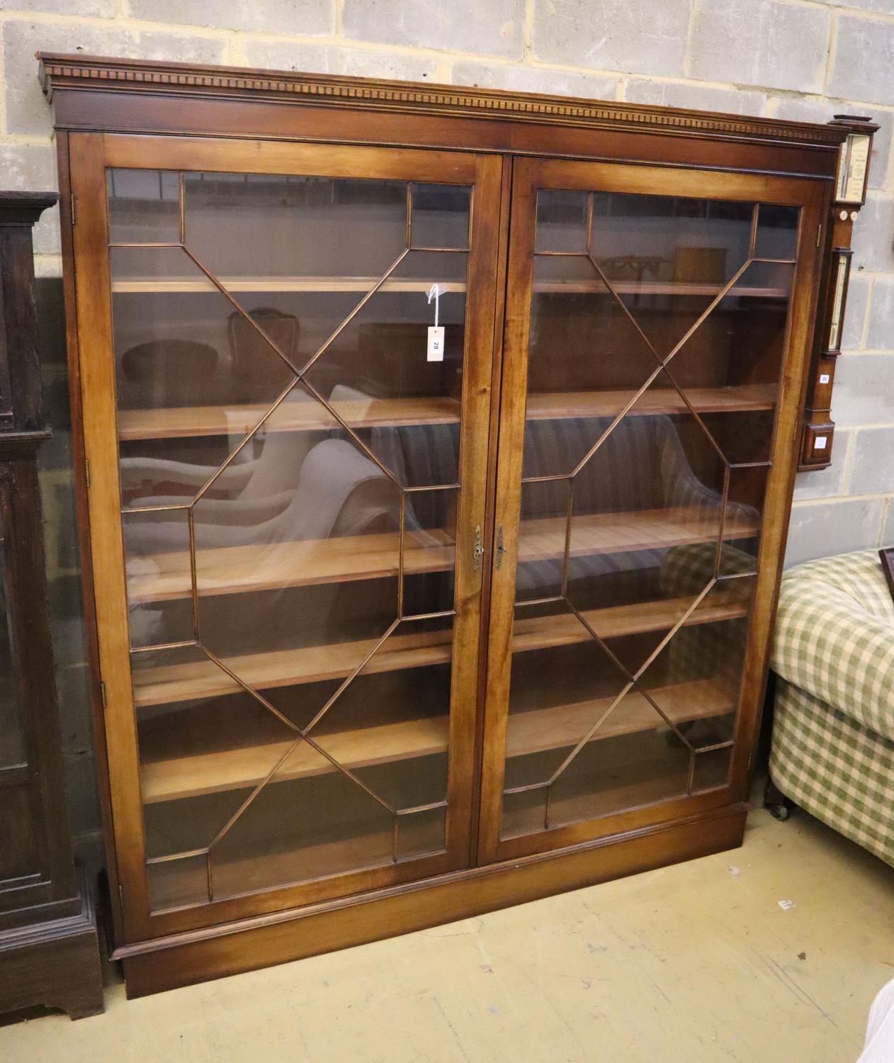 A Georgian style mahogany bookcase fitted a pair of astragal-glazed doors on plinth base, width