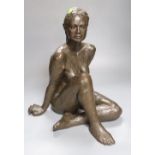 M. Pike. A bronzed terracotta figure of a seated nude female, height 38cm
