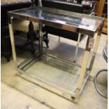 A contemporary chrome glass two tier tea trolley, width 79cm, depth 48cm, height 72cm