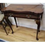 A George I red walnut serpentine top card table, with dished corners, frieze drawer and slender