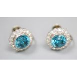 A pair of modern white metal, blue zircon and diamond cluster set circular ear clips, 11mm, gross