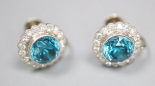 A pair of modern white metal, blue zircon and diamond cluster set circular ear clips, 11mm, gross