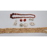 Assorted jewellery including necklaces and white metal brooches.