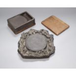 A 19th century Chinese black slate inkstone and another with wood base and cover