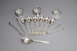 Three silver napkin rings, a set of six silver teaspoons, one other spoon and two pairs of silver