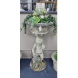 A reconstituted stone putto garden planter, height 123cm