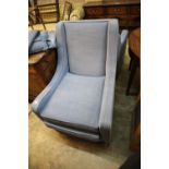 Two modern square frame armchairs with blue upholstery and a matching footstool