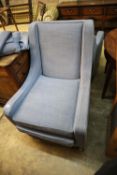 Two modern square frame armchairs with blue upholstery and a matching footstool