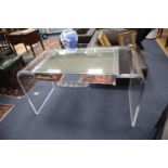 A 1970s Lucite desk with part mirrored top, width 130cm, depth 60cm, height 73cm