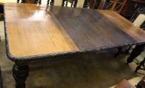 A Victorian carved oak extending dining table, with two spare leaves, length 244cm extended, width