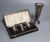 A cased modern silver three piece condiment set with two spoons and a George V silver spill vase,