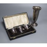 A cased modern silver three piece condiment set with two spoons and a George V silver spill vase,