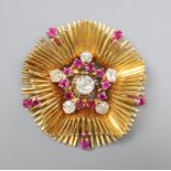 A late 1950's 18ct gold, ruby and diamond cluster set stylised flower head pendant brooch, 45mm,