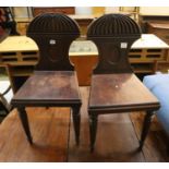 A pair of George III mahogany hall chairs