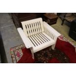 A 1960's white plastic armchair, with slatted slides