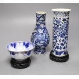 A Chinese blue and white vase with four-character mark, a similar cylindrical vase and a small bowl,