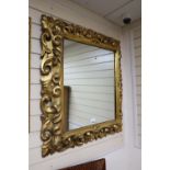 A 19th century carved Neapolitan style wall mirror, width 84cm, height 94cm