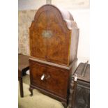 A burr walnut cocktail cabinet, width 81cm, depth 50cm, height 177cm with a collection of Tudor